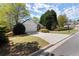 Charming home with a large driveway, well-maintained lawn, and mature trees enhancing its curb appeal at 5755 Haterleigh Dr, Alpharetta, GA 30005