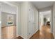 Hallway with wood floors featuring access to the living room and other rooms of the home at 5755 Haterleigh Dr, Alpharetta, GA 30005
