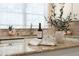 Close up on kitchen countertop with wine and glasses in front of a sunlit window and plants at 5755 Haterleigh Dr, Alpharetta, GA 30005