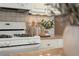 Close up of range and countertop, highlighting the modern kitchen appliances and decor at 5755 Haterleigh Dr, Alpharetta, GA 30005