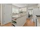 Bright eat-in kitchen with white cabinets, granite countertops, and stainless appliances at 5755 Haterleigh Dr, Alpharetta, GA 30005