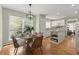 Cozy kitchen and breakfast nook with a kitchen island featuring granite counter tops and white cabinets at 5755 Haterleigh Dr, Alpharetta, GA 30005