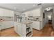Well-lit kitchen features a center island, modern appliances, and ample counter space at 5755 Haterleigh Dr, Alpharetta, GA 30005