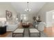 Inviting living room featuring neutral colors, ample seating, and a modern chandelier at 5755 Haterleigh Dr, Alpharetta, GA 30005