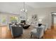 Spacious living room with hardwood floors, a fireplace, and plenty of seating for gatherings at 5755 Haterleigh Dr, Alpharetta, GA 30005