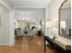 Bright living room with hardwood floors, ample seating, and a view into the dining area at 5755 Haterleigh Dr, Alpharetta, GA 30005