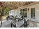 Covered outdoor patio with stylish furniture, perfect for relaxing or entertaining guests with backyard access at 5755 Haterleigh Dr, Alpharetta, GA 30005
