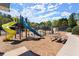 Community playground with slides, climbing structures, and a picnic table on a mulch surface with shade trees at 5755 Haterleigh Dr, Alpharetta, GA 30005