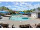 Community splash pad with shade umbrellas, chairs, and lounge seating near the main pool at 5755 Haterleigh Dr, Alpharetta, GA 30005
