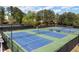Overhead view of tennis courts showcases net heights and clean court surfaces at 5755 Haterleigh Dr, Alpharetta, GA 30005
