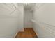 This walk-in closet features wood floors and wire shelving at 5755 Haterleigh Dr, Alpharetta, GA 30005