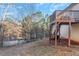 Spacious backyard with a deck, stairs and a grassy slope at 97 Spring Leaf Dr, Dallas, GA 30157
