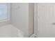 Bright bathroom featuring a shower, white trim, and a window bringing in natural light at 97 Spring Leaf Dr, Dallas, GA 30157