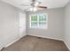 Simple bedroom featuring neutral walls, brown carpet, a ceiling fan, and a window at 97 Spring Leaf Dr, Dallas, GA 30157