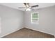 Simple bedroom featuring neutral walls, brown carpet, a ceiling fan, and a window at 97 Spring Leaf Dr, Dallas, GA 30157