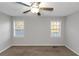 Bedroom featuring neutral paint, carpet, a ceiling fan, and two windows for ample natural light at 97 Spring Leaf Dr, Dallas, GA 30157
