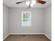 Simple bedroom featuring neutral walls, brown carpet, and a window at 97 Spring Leaf Dr, Dallas, GA 30157