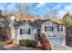 Charming home with a two-car garage, black shutters, wood stairs, and partially fenced front yard at 97 Spring Leaf Dr, Dallas, GA 30157