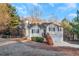 Charming home with a two-car garage, black shutters, wood stairs, and partially fenced front yard at 97 Spring Leaf Dr, Dallas, GA 30157