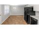 The kitchen boasts black appliances, white cabinets, and plenty of counter space at 97 Spring Leaf Dr, Dallas, GA 30157