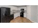 Well-lit kitchen features ample cabinet space, black appliances, and durable tile flooring at 97 Spring Leaf Dr, Dallas, GA 30157