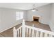 Spacious living room featuring a ceiling fan, window, and a cozy brick fireplace at 97 Spring Leaf Dr, Dallas, GA 30157