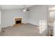 Open living room with a brick fireplace, neutral paint, carpet, and a ceiling fan at 97 Spring Leaf Dr, Dallas, GA 30157