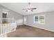 Bright living room boasts carpet, a fan, and a window letting in natural light from outside at 97 Spring Leaf Dr, Dallas, GA 30157