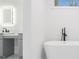 Elegant bathroom with a freestanding tub, modern fixtures, and lit mirror at 2195 Springdale Sw Rd, Atlanta, GA 30315