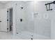 Luxurious bathroom with a glass-enclosed shower, marble tiling, and modern fixtures at 2195 Springdale Sw Rd, Atlanta, GA 30315