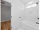 Bright bathroom featuring a modern tub, tiled walls, and a door to the bedroom at 2195 Springdale Sw Rd, Atlanta, GA 30315