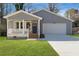 Charming bungalow-style home with a freshly painted gray exterior, inviting porch, and attached garage at 2195 Springdale Sw Rd, Atlanta, GA 30315