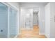 The hallway boasts hardwood floors, neutral paint, and access to a bathroom and backyard at 2195 Springdale Sw Rd, Atlanta, GA 30315