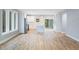 Open kitchen featuring white cabinets, a waterfall island, and stainless steel appliances with hardwood floors at 2195 Springdale Sw Rd, Atlanta, GA 30315