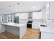 New kitchen with a large quartz island, stainless appliances, and hardwood floors at 2195 Springdale Sw Rd, Atlanta, GA 30315