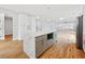 Modern kitchen with a waterfall island, stainless steel appliances, and an open layout to the living area at 2195 Springdale Sw Rd, Atlanta, GA 30315