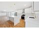 Bright, open kitchen featuring white cabinets, quartz countertops, and stainless steel appliances at 2195 Springdale Sw Rd, Atlanta, GA 30315