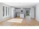 Bright and spacious living area featuring hardwood floors and a modern design, leading into a white kitchen at 2195 Springdale Sw Rd, Atlanta, GA 30315