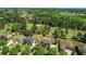 Overhead view of a lush, green golf course community with elegant homes nestled among the trees at 5204 Heron Bay Blvd, Locust Grove, GA 30248