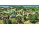 Picturesque aerial view of a community with lush greenery, homes, and golf course by the lake at 5204 Heron Bay Blvd, Locust Grove, GA 30248