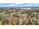 Stunning aerial view of a neighborhood with mature trees, a pond, and well-maintained homes at 5204 Heron Bay Blvd, Locust Grove, GA 30248