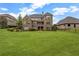 Large, level backyard with mature trees and landscaping, perfect for outdoor activities and entertaining at 5204 Heron Bay Blvd, Locust Grove, GA 30248