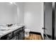 Modern bathroom with a marble countertop, white walls, and dark cabinetry at 5204 Heron Bay Blvd, Locust Grove, GA 30248