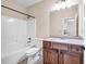 Bathroom featuring a tub/shower combo, toilet, and wooden vanity with a light countertop at 5204 Heron Bay Blvd, Locust Grove, GA 30248