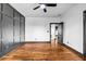 Comfortable bedroom with hardwood floors, wall trim, and a ceiling fan at 5204 Heron Bay Blvd, Locust Grove, GA 30248
