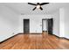 Spacious bedroom with hardwood flooring, ceiling fan, and two entry doors that let in tons of natural light at 5204 Heron Bay Blvd, Locust Grove, GA 30248