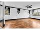 Bright bedroom featuring hardwood floors, large windows, and a ceiling fan at 5204 Heron Bay Blvd, Locust Grove, GA 30248