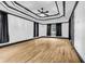 Large bedroom featuring hardwood floors, tray ceilings, and dark trim at 5204 Heron Bay Blvd, Locust Grove, GA 30248