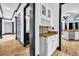 Hallway featuring a built-in bar area, hardwood floors, and decorative lighting at 5204 Heron Bay Blvd, Locust Grove, GA 30248