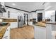 Modern kitchen with stainless steel appliances, granite counters, and hardwood floors at 5204 Heron Bay Blvd, Locust Grove, GA 30248